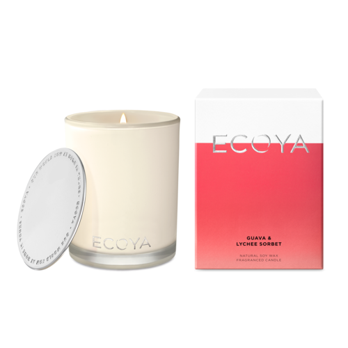 An Ecoya Madison candle with a white label and a silver lid, next to its pink and white box packaged for Guava & Lychee fragrance.