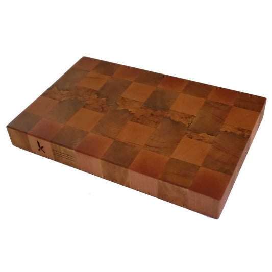 A rectangular end grain chopping board with a chequered pattern of different shades of brown, made from native New Zealand Rimu and Beech.