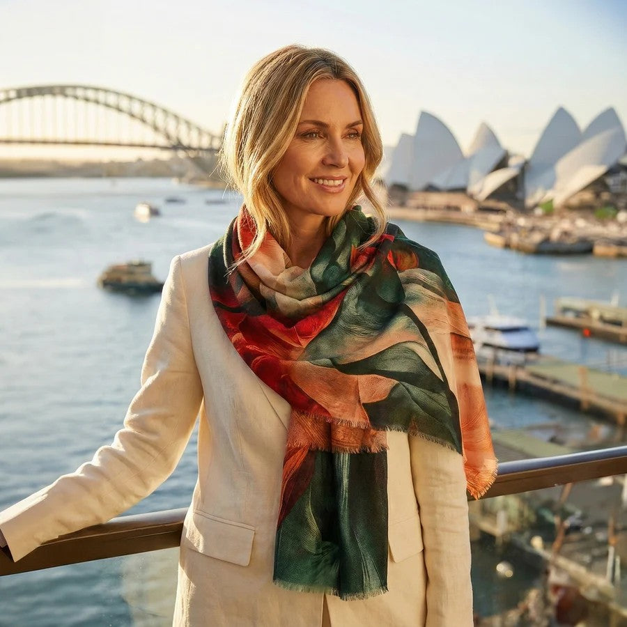 Woman wearing a colorful merino scarf with the Sydney Opera House and Harbour Bridge in the background.