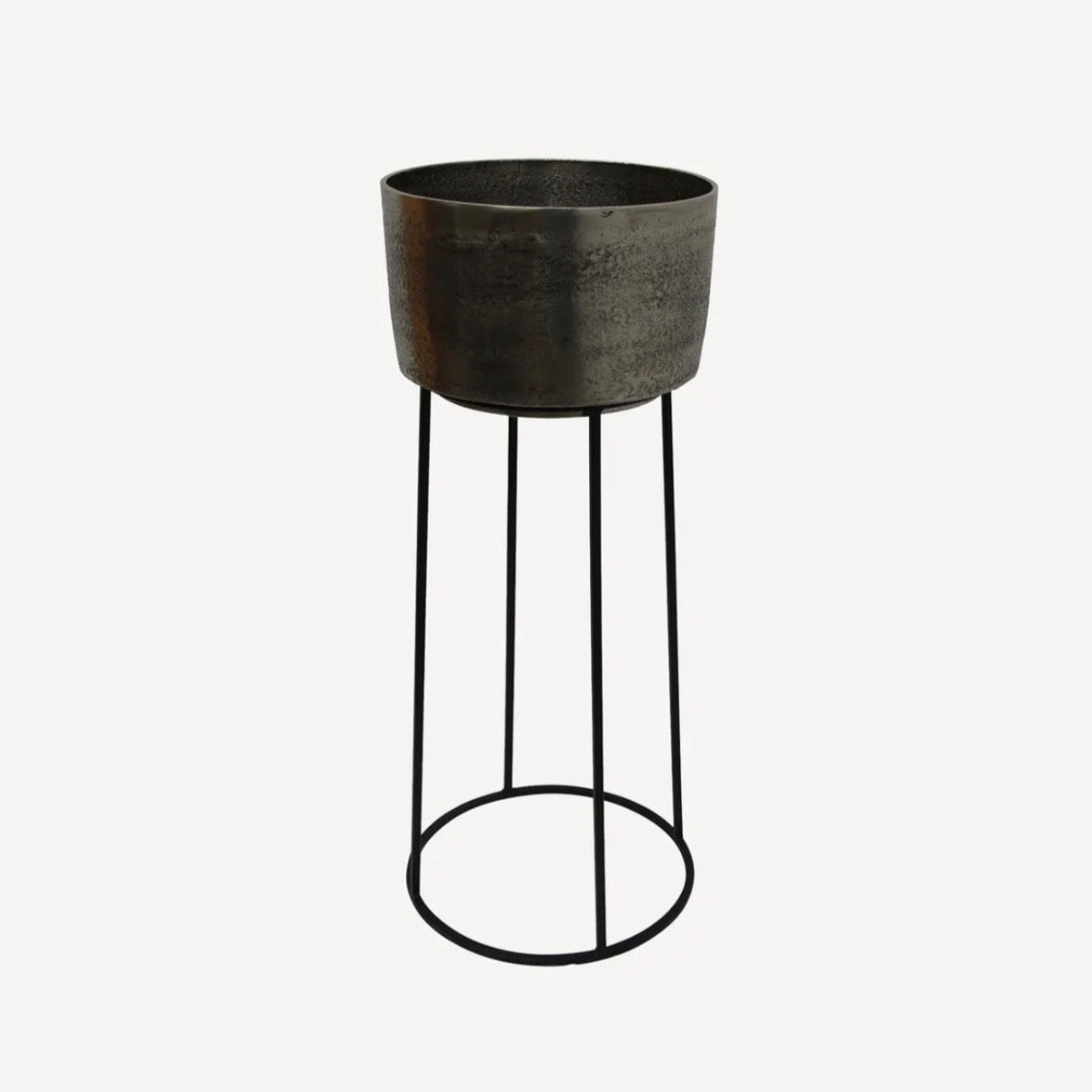 Decorative pot on a stand with a textured surface and black metal legs 