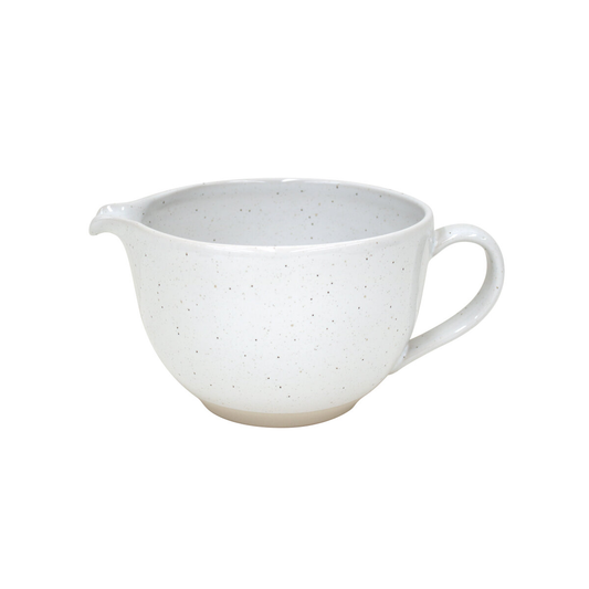 White ceramic pitcher with speckled textur on a white background