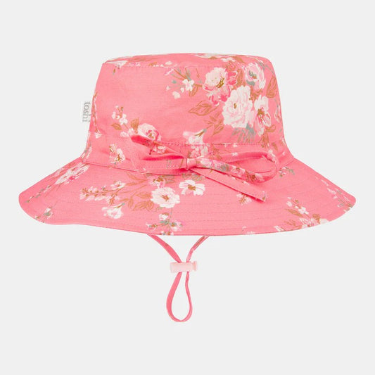 A pink floral sun hat with a wide brim and a head tie for adjustable sizing.