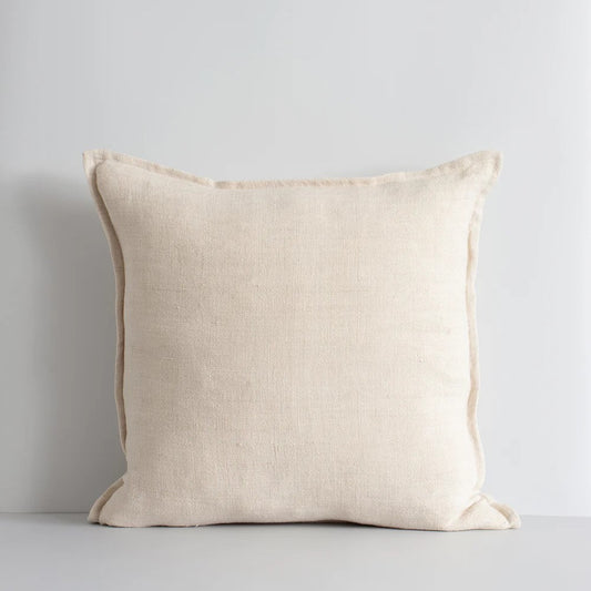 A square-shaped cushion with a flange edge, in a nude beige color, made from linen fabric.