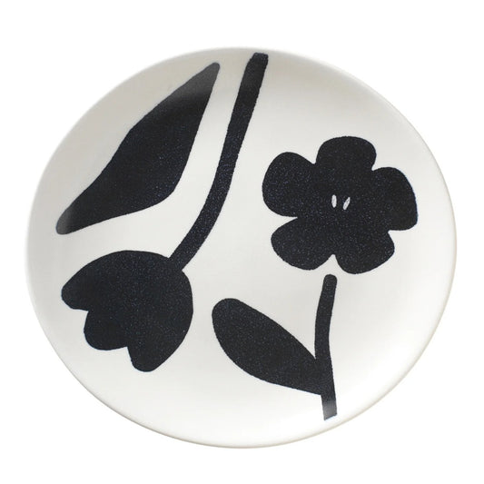 Round white plate with black floral design 