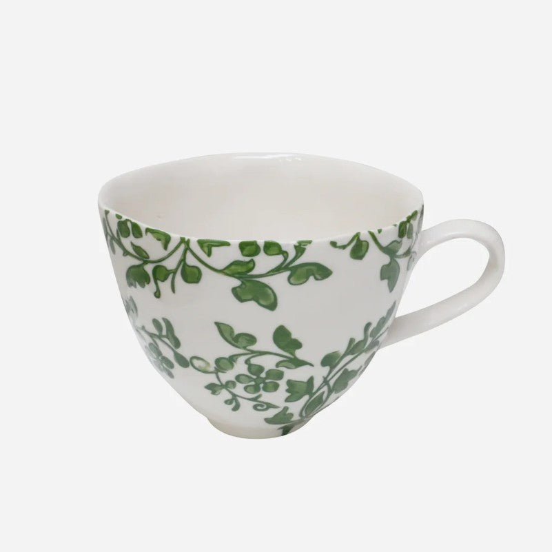 White mug with green leaf pattern