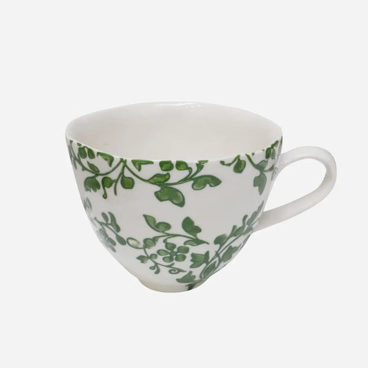 White mug with green leaf pattern