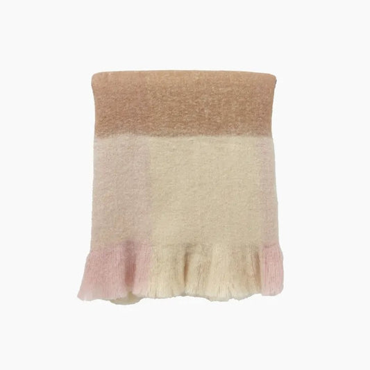 A folded dusky pink throw with fringed detailing, showing a mix of rose, mink, and beige tones.