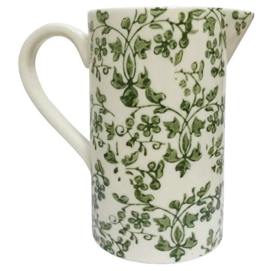 White ceramic pitcher with green floral pattern