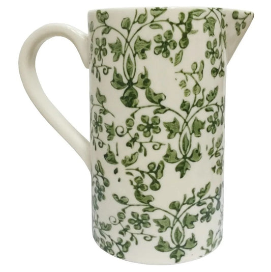White ceramic pitcher with green floral pattern