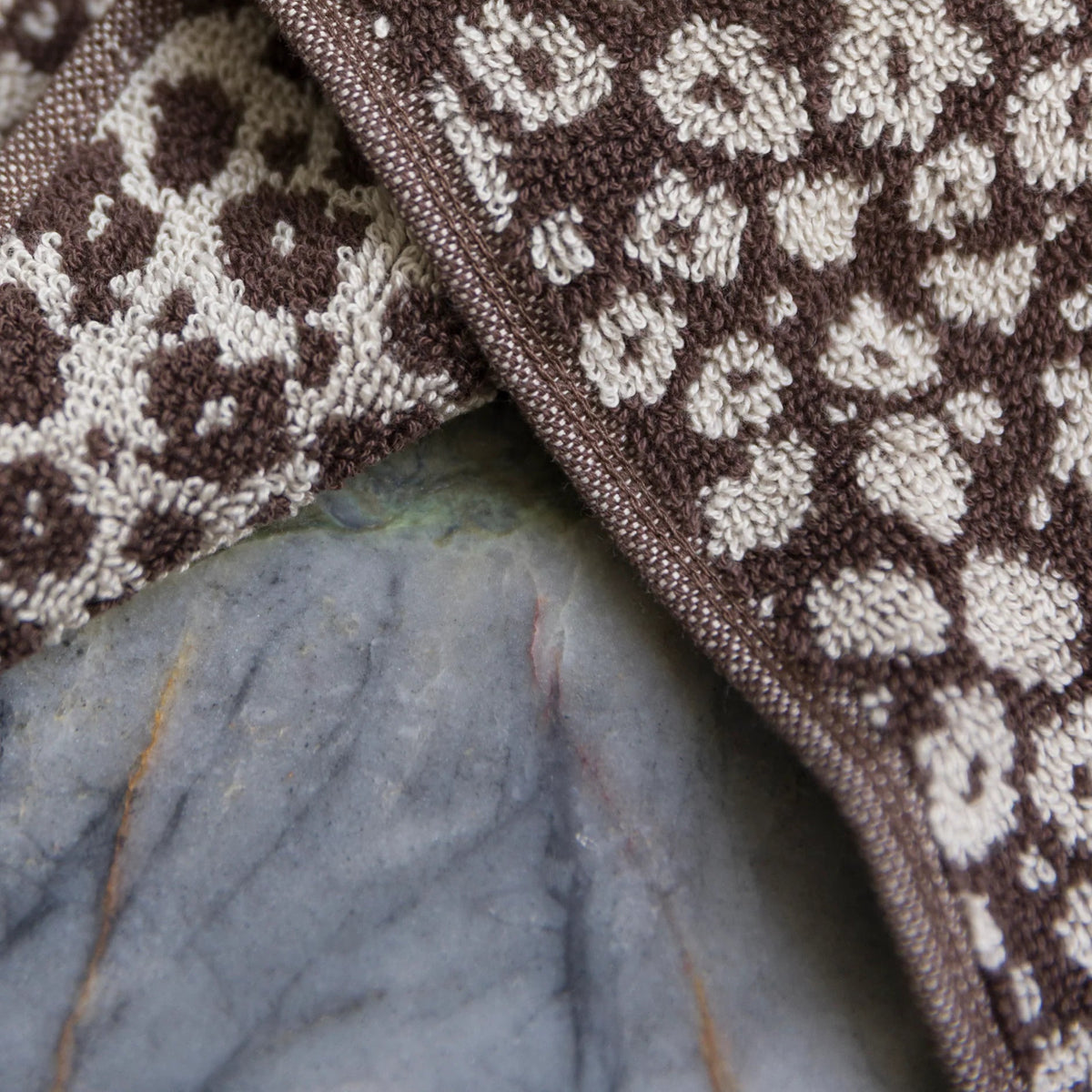 Close-up of a brown and white patterned fabric on a leaf