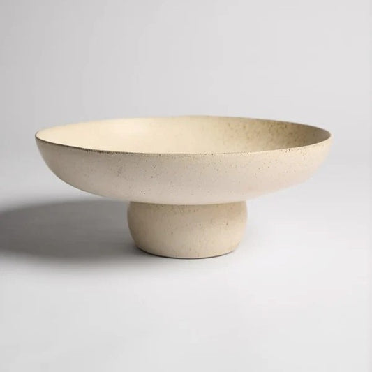 Beige ceramic bowl on a stand 