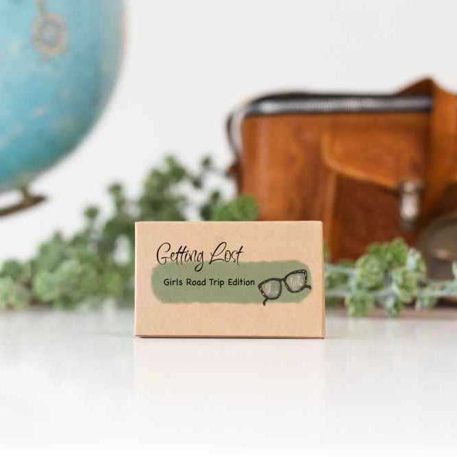 A product image featuring a game box titled 'Getting Lost - Girls Road Trip Edition'