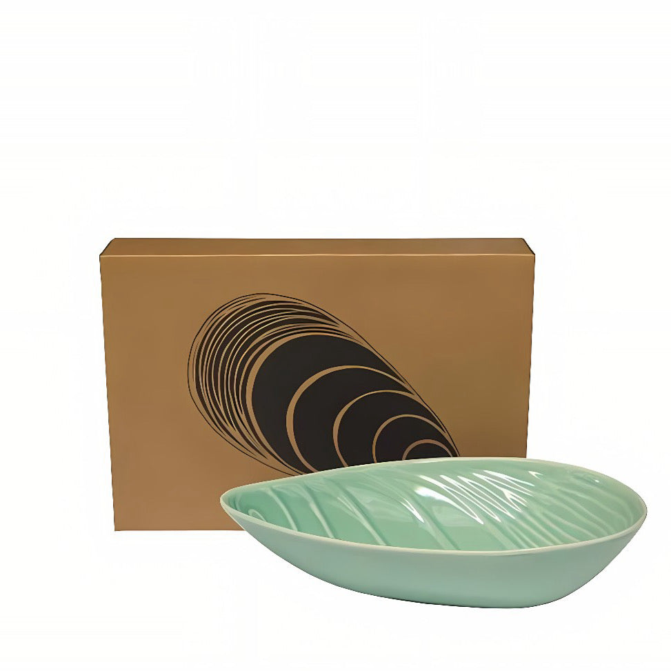 Green ceramic bowl in the shape of a New Zealand mussel 