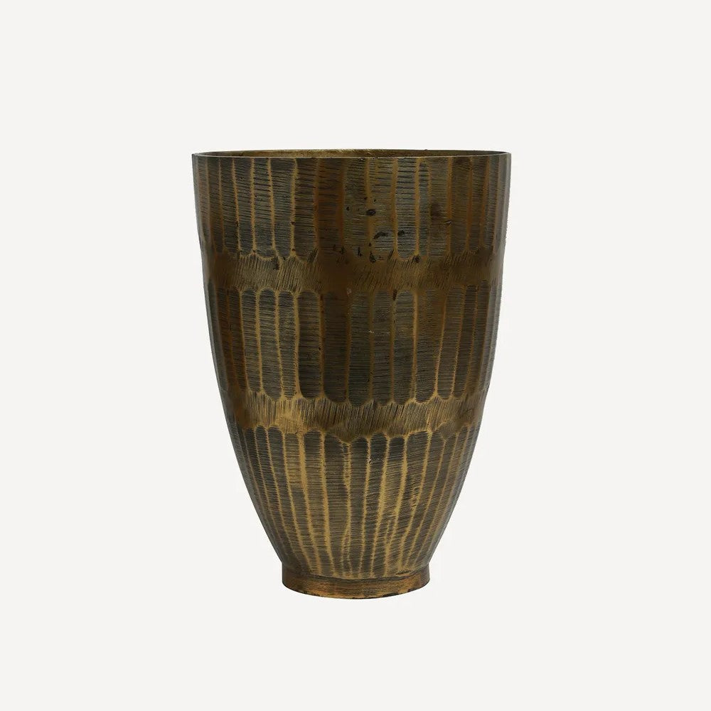 A hammered textured brass colored aluminum pot 