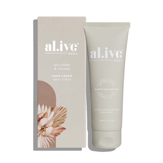A tube of al.ive Body Sea Cotton & Coconut Hand Cream stands next to its matching beige packaging box on a clean white background.