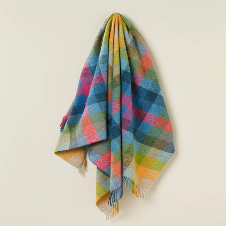 Colorful wool plaid blanket on a beige background