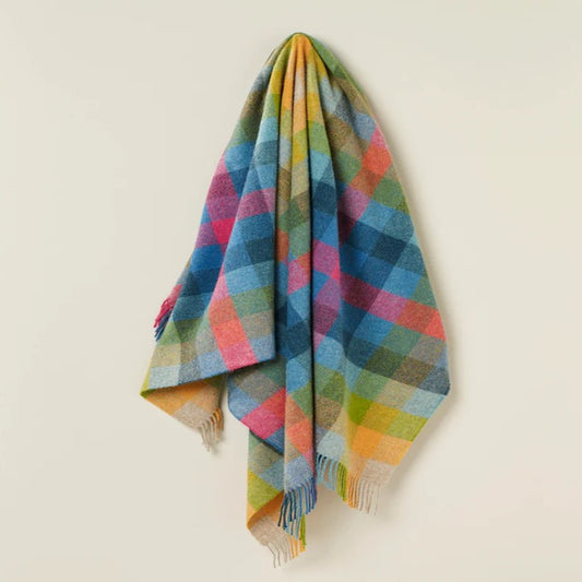 Colorful wool plaid blanket on a beige background