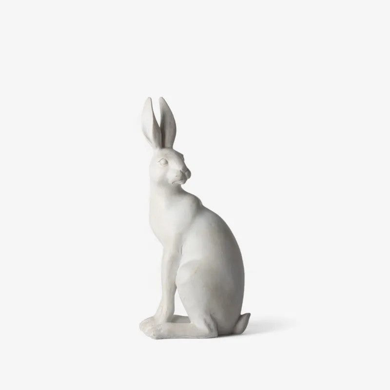 White rabbit figurine on a light gray background