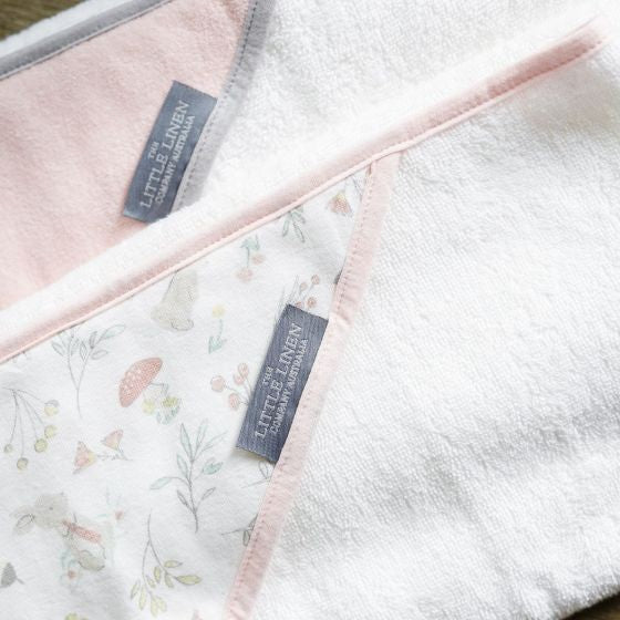 Floral-patterned towel with 'Little Linen' label on a white background