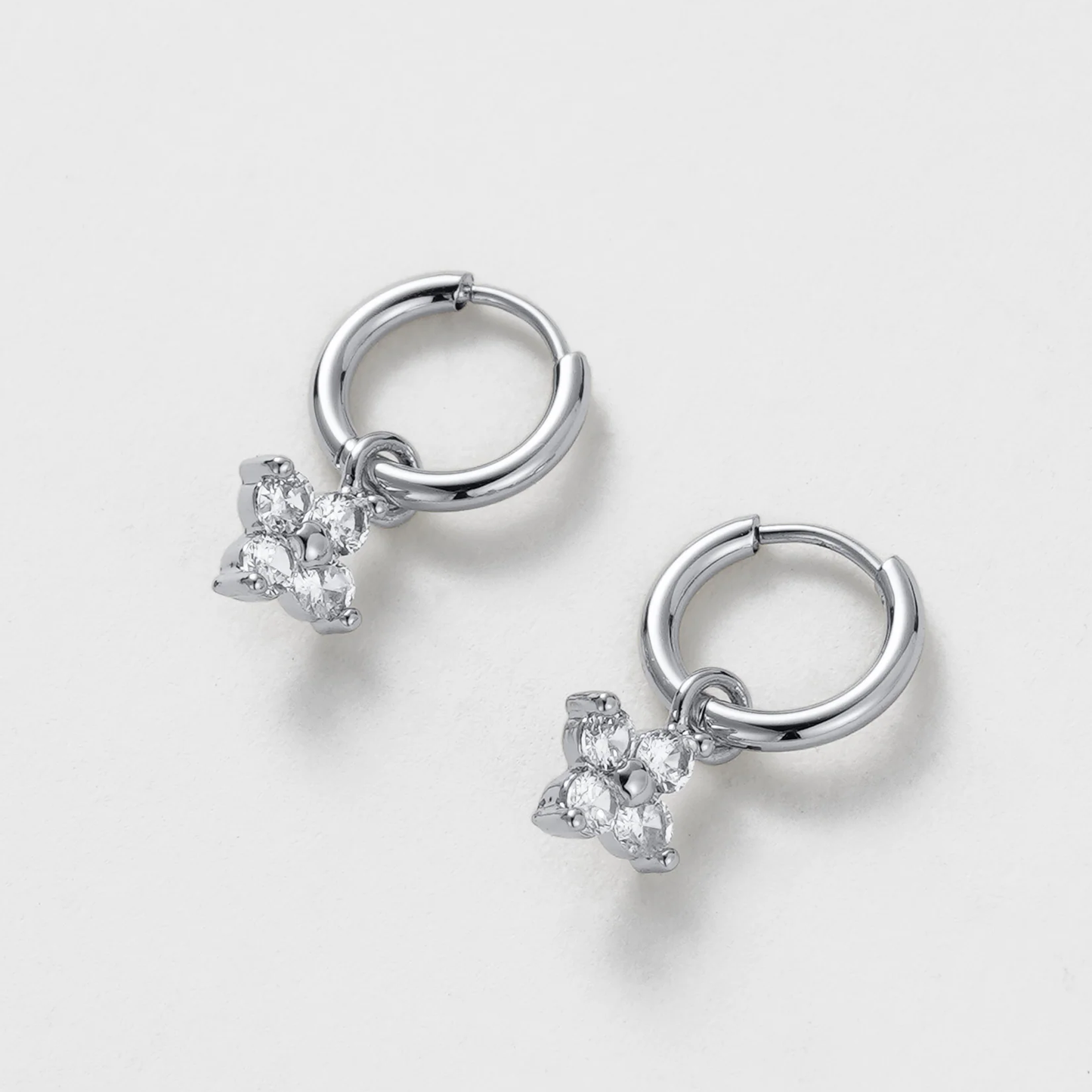 Pair of silver hoop earrings with star-shaped gemstones 