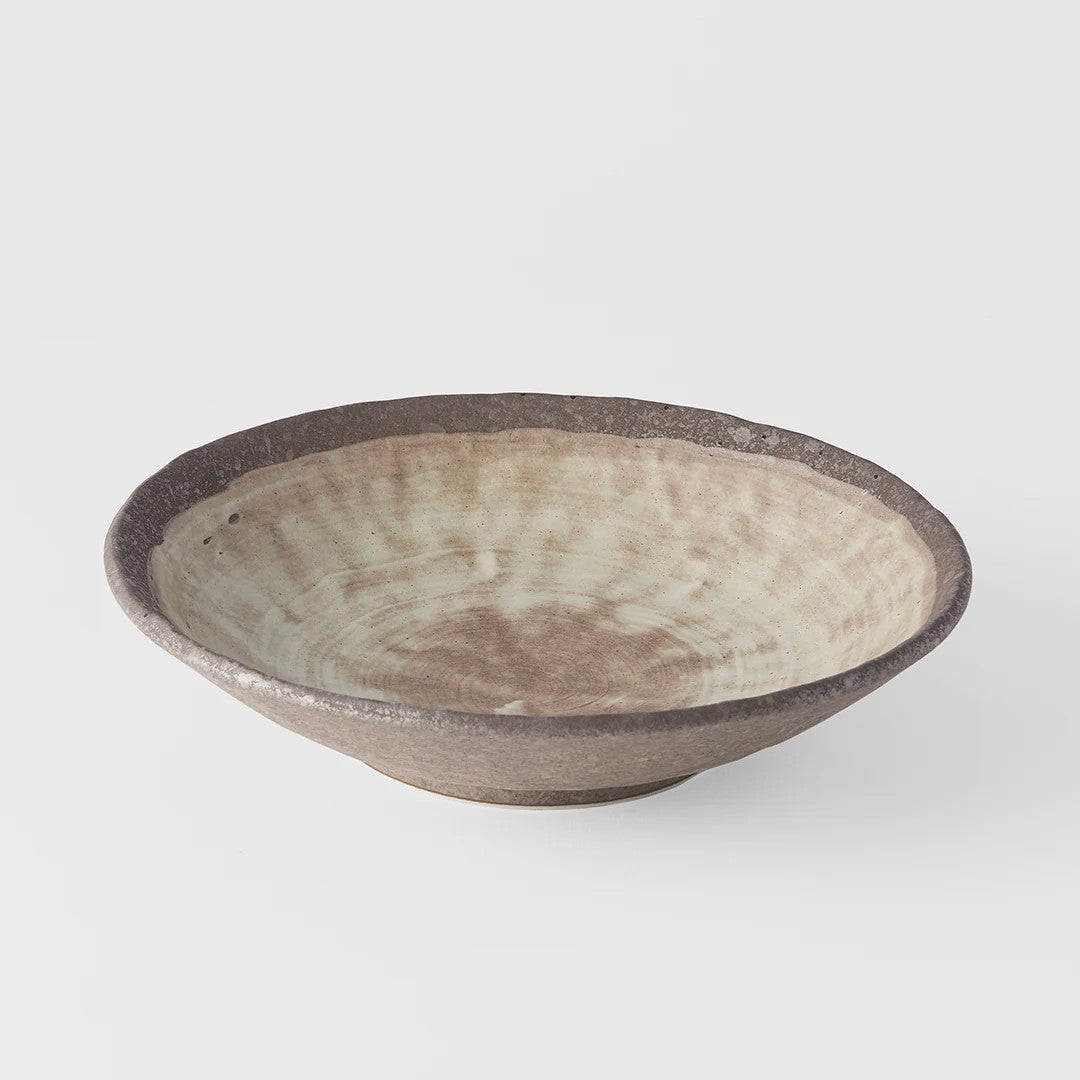 A large shallow bowl with a swirling golden ochre pattern on a white background, signifying a Nin-Rin brand product.