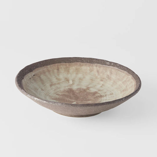 A large shallow bowl with a swirling golden ochre pattern on a white background, signifying a Nin-Rin brand product.
