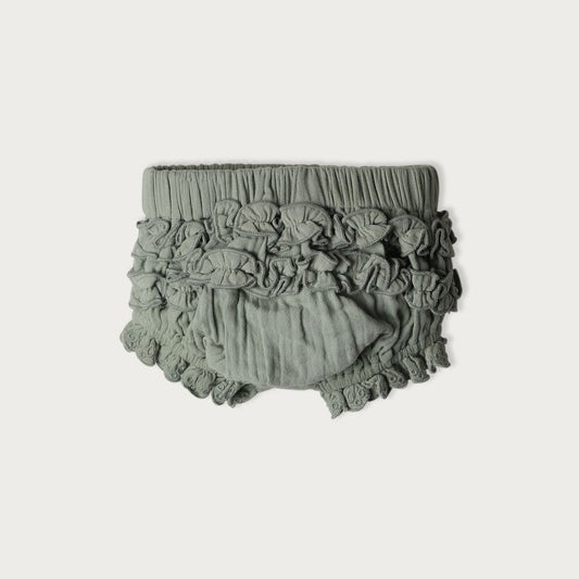 A pair of green ruffle bloomers for babies, made from organic cotton muslin,