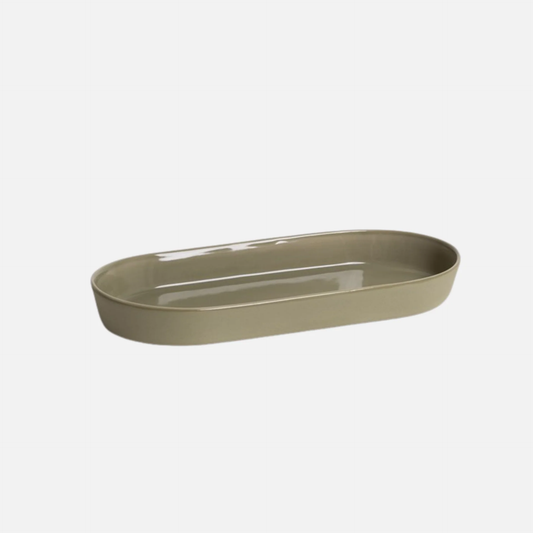 Oval beige ceramic dish on a white background