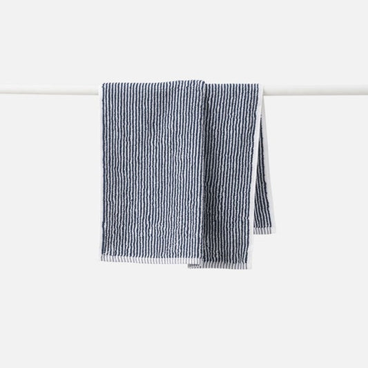 navystriped towel hanging on a white rack against a white background