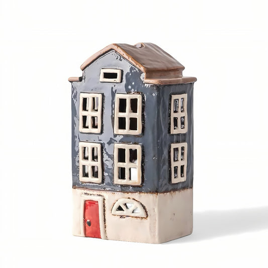 Ceramic house-shaped container with a red door