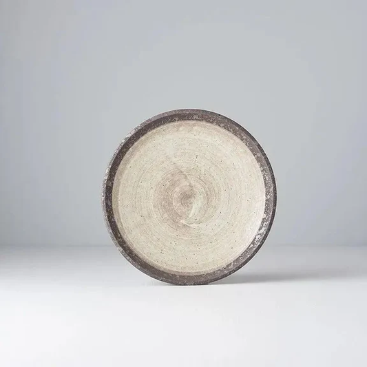 Round ceramic plate with textured surface