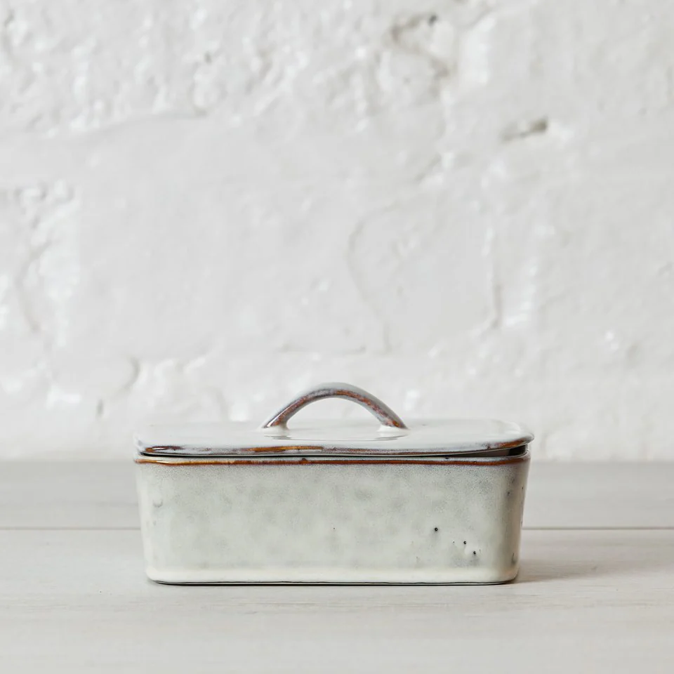 White ceramic butter dish with a brown rim 