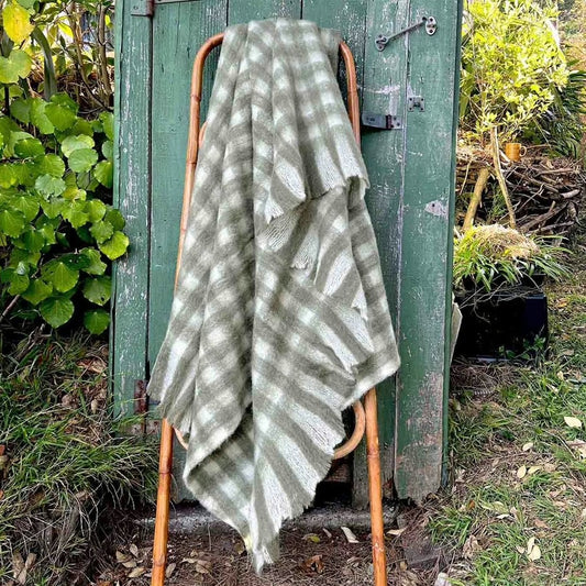 Green and white patterned woolen throw blanket 