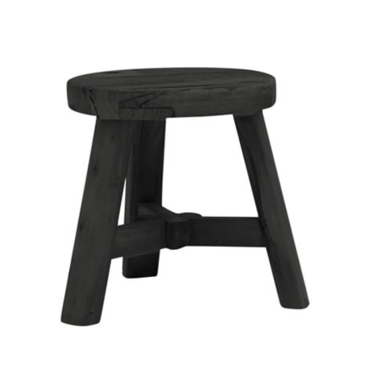 A rustic black wooden stool with a round seat and four angled legs connected by a central stretcher bar, shown on a plain white background.