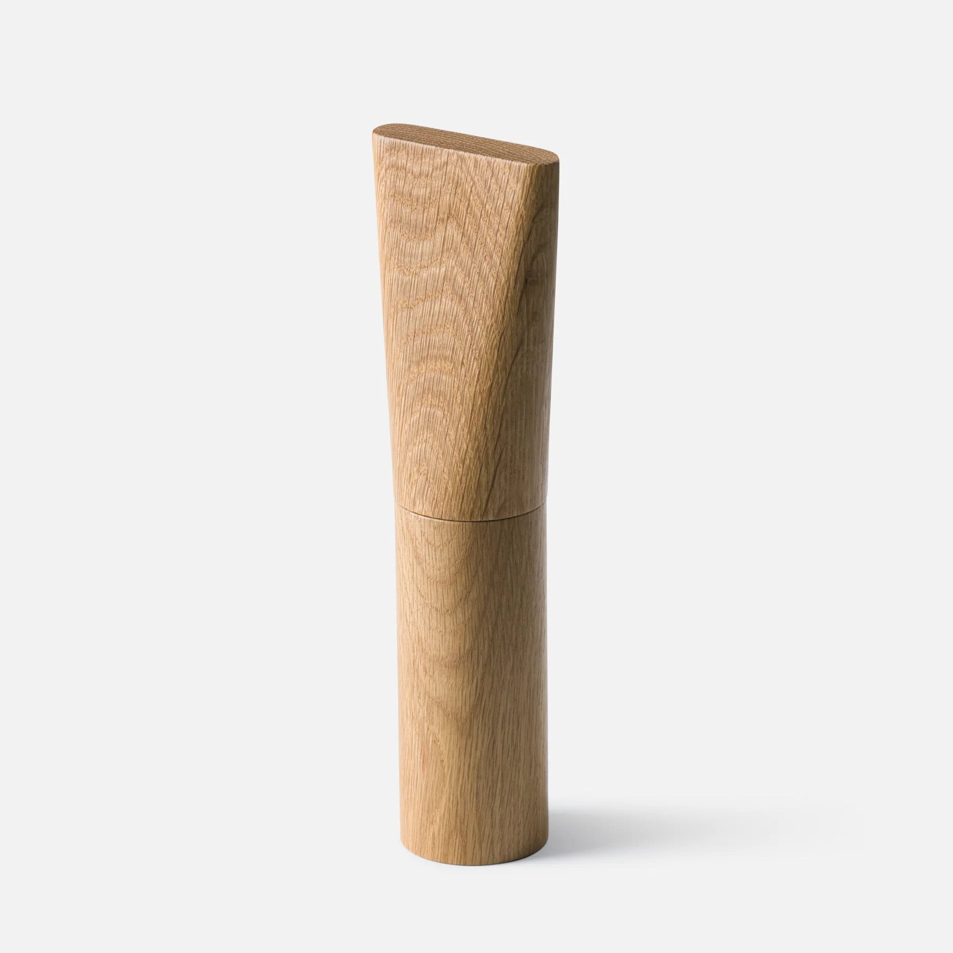 A minimalist wooden cylindrical container or candle holder with a visible wood grain texture, shown on a clean light gray background.