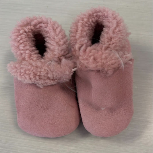 A pair of pastel pink lambskin booties with elastic cuffs and sheepskin lining.