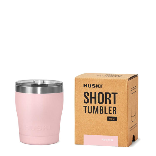 A powder pink Huski Short Tumbler 2.0 next to its packaging box, with the product name and the brand Huski visible on the box.