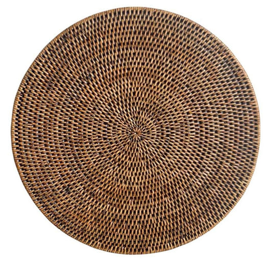 A round brown rattan placemat with a woven pattern.