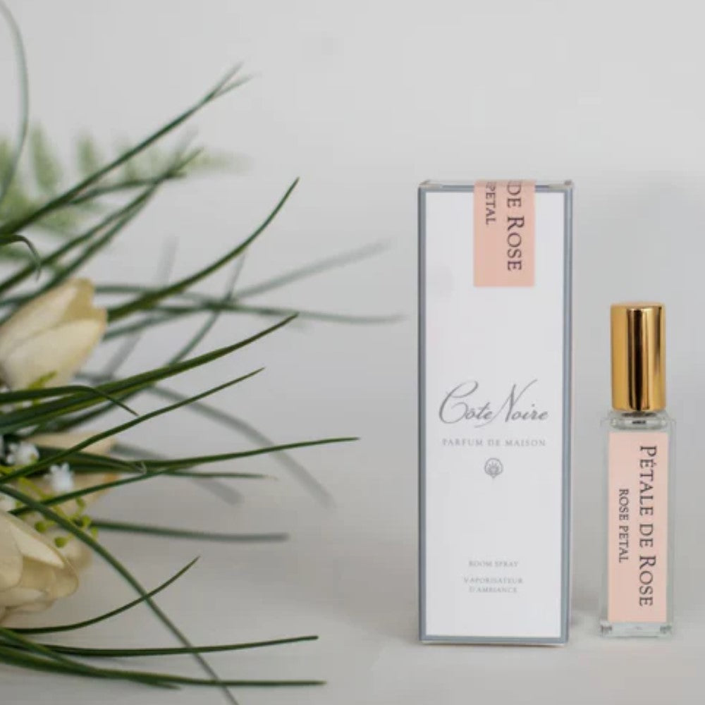 A bottle of Cote Noire Rose Petal Fragrance with a gold cap