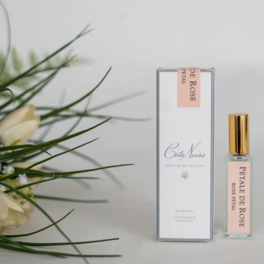 A bottle of Cote Noire Rose Petal Fragrance with a gold cap
