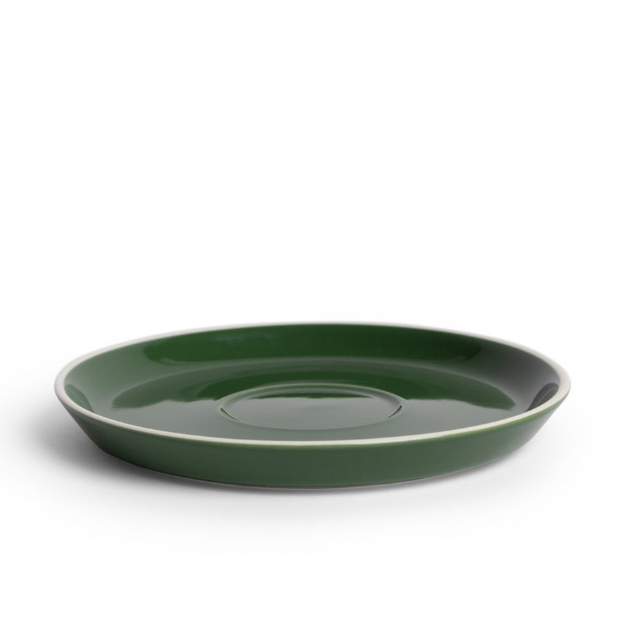 A green porcelain saucer designed for holding coffee or espresso cups.