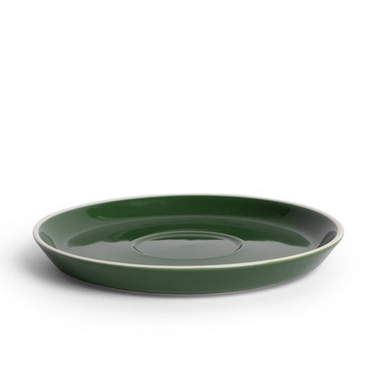A green porcelain saucer designed for holding coffee or espresso cups.