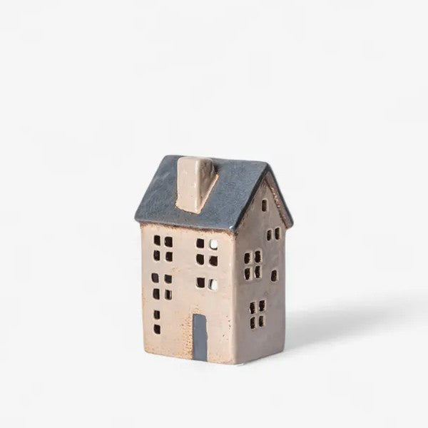 Ceramic house-shaped lantern on a white background
