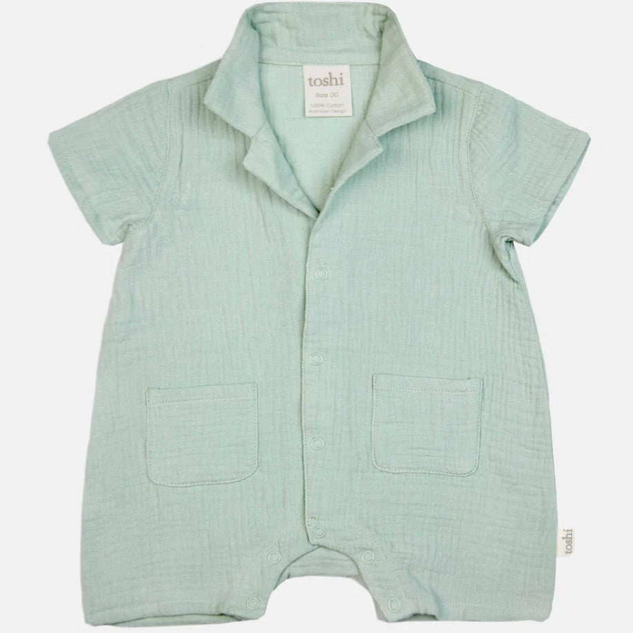 Light green baby romper with 'toshi' label
