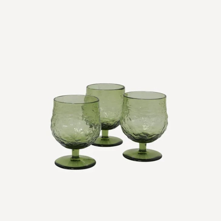 A set of four green wine goblets with an irregular, mouth-blown design, displayed against a neutral background.