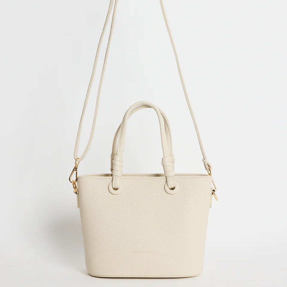 Beige handbag with a strap on a light gray background