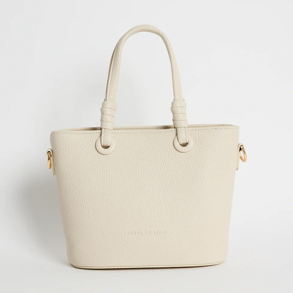 Beige handbag with gold accents on a light gray background