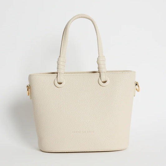 Beige handbag with gold accents on a light gray background