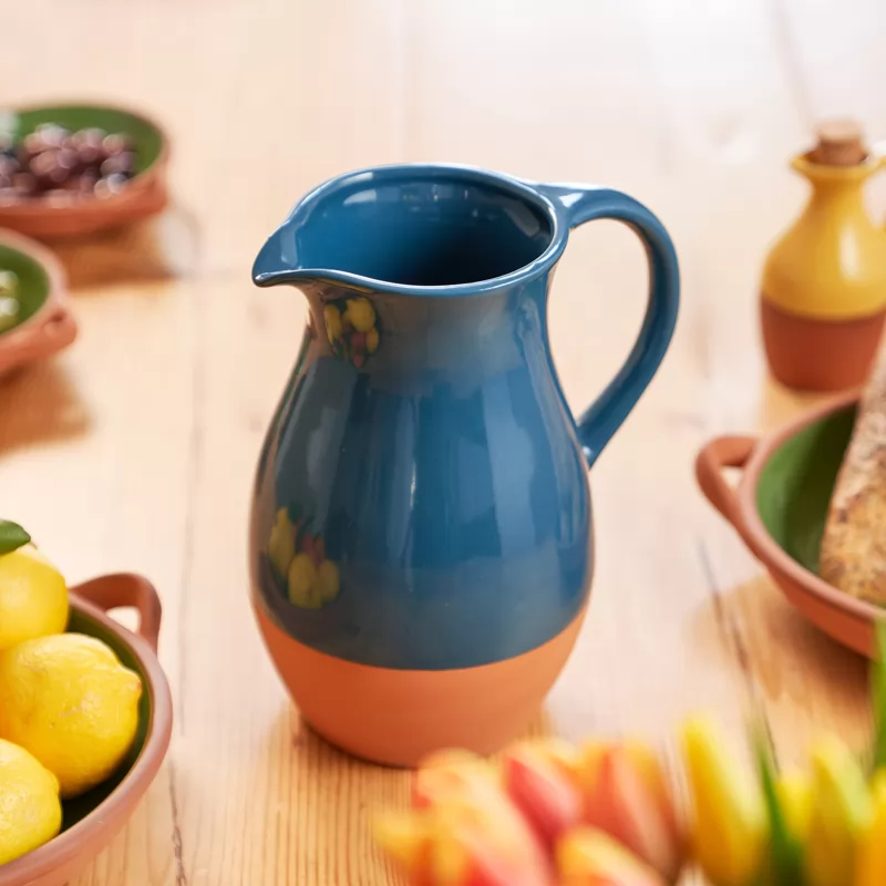 Blue terracotta pitcher on a wooden table