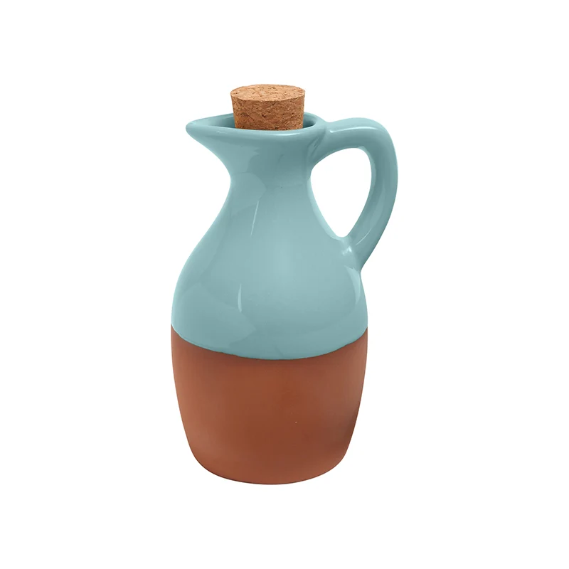 A terracotta oil drizzlier glazed in a light blue coloring 
